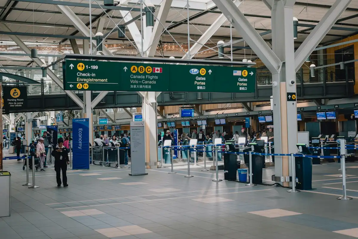 Travellers in an airport arrivals hall before a private transfer