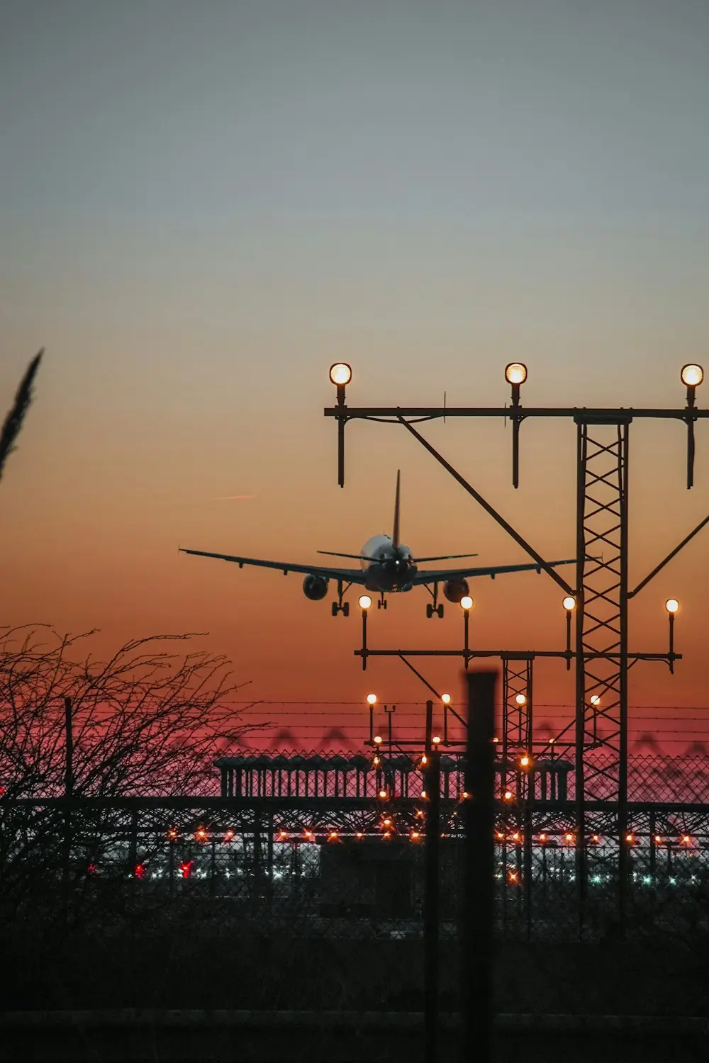 Barcelona airport transfer: a plane landing at Barcelona-El Prat Airport at sunset