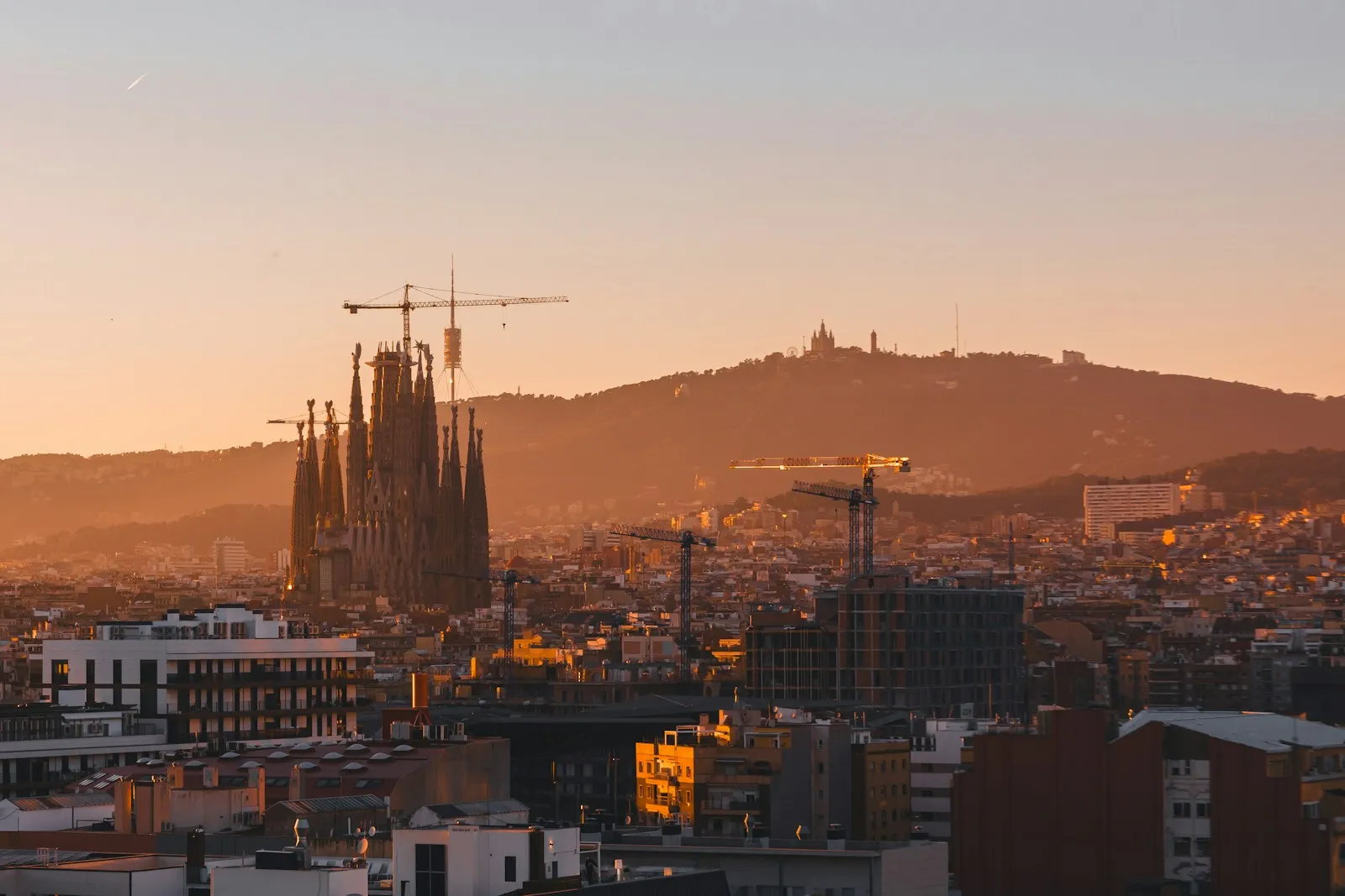 Barcelona skyline at sunset with the Sagrada Família and Tibidabo hill