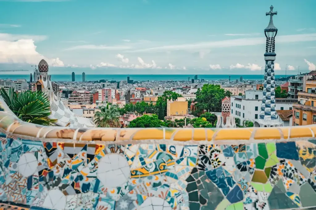 Mosaic serpentine bench and city view in the Monumental Zone, included with Park Güell tickets
