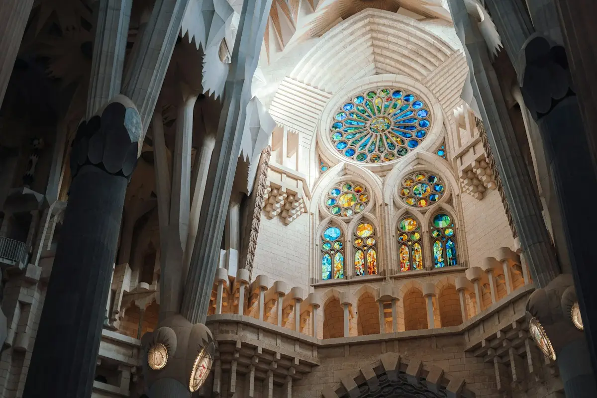 Interior of the Sagrada Família with stained glass windows and tree-like columns